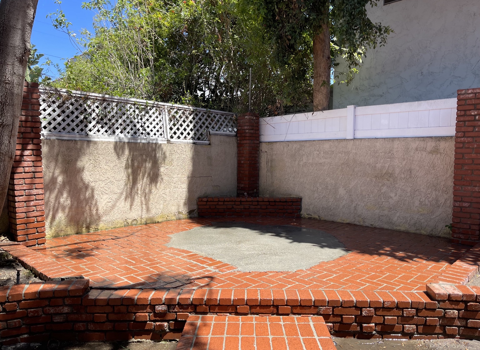 Clean red brick patio and stucco walls
